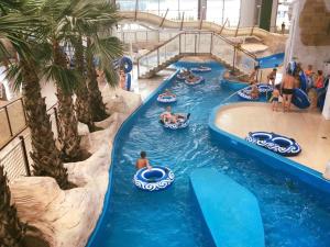 a water slide at a water park with people tubing at Apartament Aquasfera in Reda