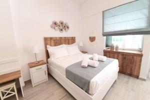 A bed or beds in a room at Elia Luxury Suite, Corfu Town