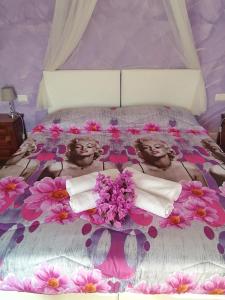 two women in a bed with flowers on it at B&B Villa la Bouganville in Camaiore