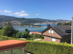 a house with a view of a body of water at Playa America! in Nigrán