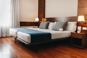 Postel nebo postele na pokoji v ubytování Oriente Atiram Hotel