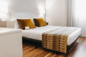 Postel nebo postele na pokoji v ubytování Oriente Atiram Hotel