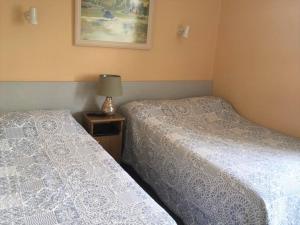 two beds sitting next to each other in a room at Brassil Bed and Breakfast in Ballyheigue
