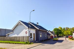 a small house on the side of a street at Country Home in Ventspils