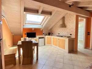 a large kitchen with a table and a window at La Chiocciola in Momo
