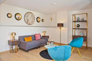 a living room with a couch and a table at Hôtel La Villa Port d'Antibes & Spa in Antibes