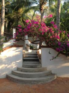 a set of stairs with pink flowers at Casa Flor de Mar in Zipolite