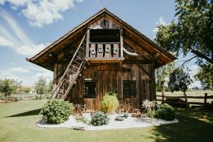 a small log cabin with a ladder on it at RANČ JUREŠ - Relaxing Countryside Escape in Ljutomer