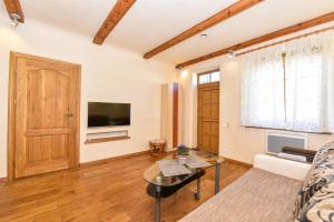 a living room with a couch and a table at Country Home in Ventspils