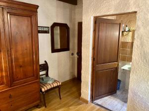 a bathroom with a wooden door and a sink at Finca Ses Fontanelles in Andratx