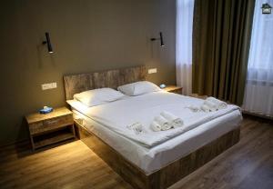 a bedroom with a large bed with towels on it at Guest House in Gyumri in Gyumri