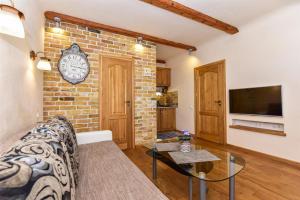 a living room with a couch and a brick wall at Country Home in Ventspils +11 photos