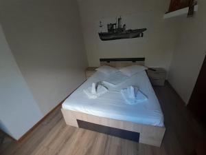a bedroom with a bed with two white pillows at Delta ca Odinioara in Sulina