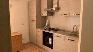 a kitchen with a stove and a sink at Home Fiesta in Giardini Naxos +10 photos