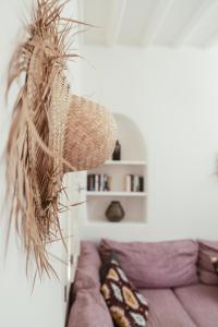 a rattan basket hanging over a couch in a living room at MOOI Skylight in Mikonos