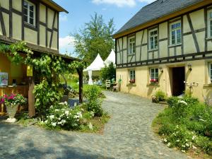 a house with a cobblestone driveway next to a building at Chalet am Kurpark in Boppard