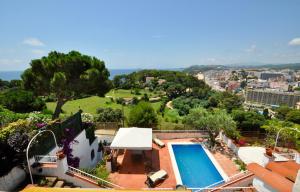 a villa with a swimming pool on top of a building at Villa Cala Trons in Lloret de Mar