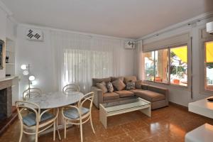 a living room with a couch and a table at Villa Cala Trons in Lloret de Mar