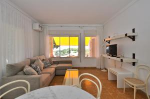 a living room with a couch and a table at Villa Cala Trons in Lloret de Mar