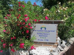 a sign for the forest house kk holiday home apartment park at The Forest House Krk 1 in Kras