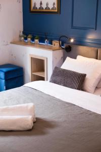a bedroom with two beds and a blue wall at Lviv4U in Lviv