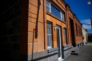 a brick building with windows on the side of it at Gyurji Home - Guest House in Gyumri in Gyumri