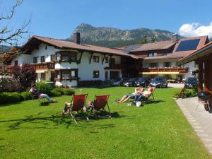 a group of people sitting in chairs in a yard at Das Apartment Rief daheim beim Wanderprofi Adults Only in Tannheim