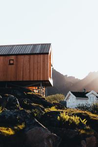 a wooden building on top of a hill at Hattvika Lodge in Ballstad