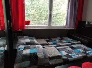 a bed sitting in a room with a window at Apartament Aurelia in Ustka