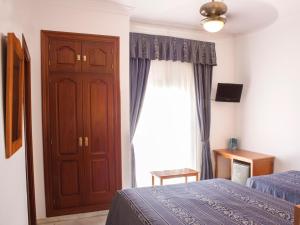Postel nebo postele na pokoji v ubytování HOTEL GUADALUPE