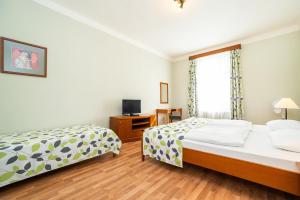 Postel nebo postele na pokoji v ubytování Hotel Orion