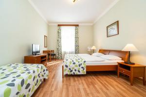 Postel nebo postele na pokoji v ubytování Hotel Orion