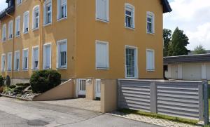 un edificio giallo con un cancello di fronte di Urlaubsdomizil Lengefeld a Lengefeld