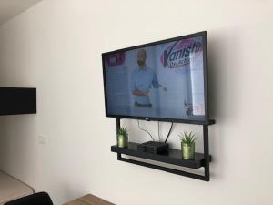 a flat screen tv sitting on a wall at FLORIDE in Knokke-Heist