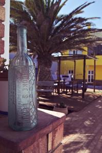 a glass bottle sitting on top of a table at Haus Sandrose in Lüderitz