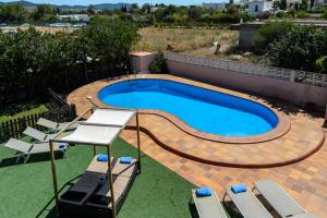 a swimming pool on top of a house at Sa Carroca Villa in Sant Josep de sa Talaia