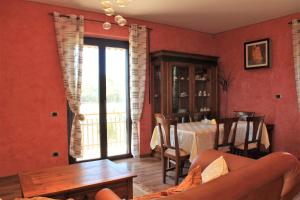 a living room with a table and a dining room at Il Vivaio in Tarquinia