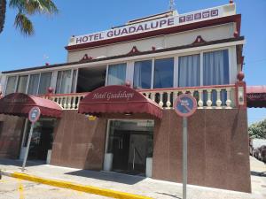 a hotel building with a hotel guadalupe risk sign in front at HOTEL GUADALUPE in Chipiona