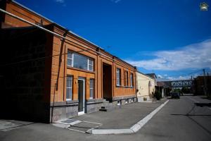 a building on a street next to a road at Gyurji Home - Guest House in Gyumri in Gyumri