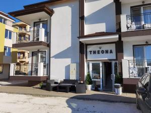 a store with a sign that reads thema on a building at Guest House Theona in Obzor