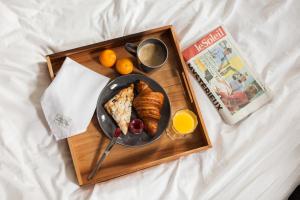 
a wooden table topped with a tray of food at Hôtel des Coutellier in Quebec City
