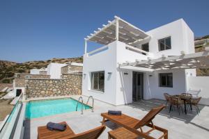 a villa with a swimming pool and a patio at CIEL BOUTIQUE VILLAS in Afiartis