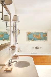 
a bathroom with a sink and a bathtub at Caruso, A Belmond Hotel, Amalfi Coast in Ravello
