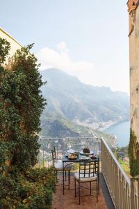 a patio area with a table and chairs at Caruso, A Belmond Hotel, Amalfi Coast in Ravello