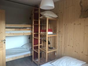 a room with bunk beds and a bed and a lamp at Vue Panoramique - 800m pistes Hohneck - Wifi - classé 3 étoiles in La Bresse