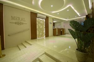 a lobby of a hotel with a potted plant at منزال الحزم للشقق المخدومة in Ar Rass