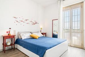 Schlafzimmer mit einem Bett mit blauer Decke in der Unterkunft Bolognina Cozy Apartment in Bologna