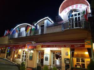 a building with a balcony and a hotel at night at Club Haus 502 Kalocsa in Kalocsa