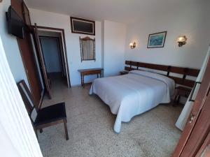 Säng eller sängar i ett rum på Hotel Buenavista