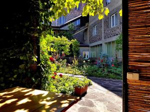 a garden with flowers in front of a building at Mina Hotel in Goris +50 photos